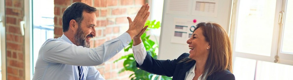 Partners high-five'ing after agreeing to working together in affiliate marketing